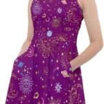 Woman posing in a purple sleeveless dress adorned with constellation and starry night patterns.