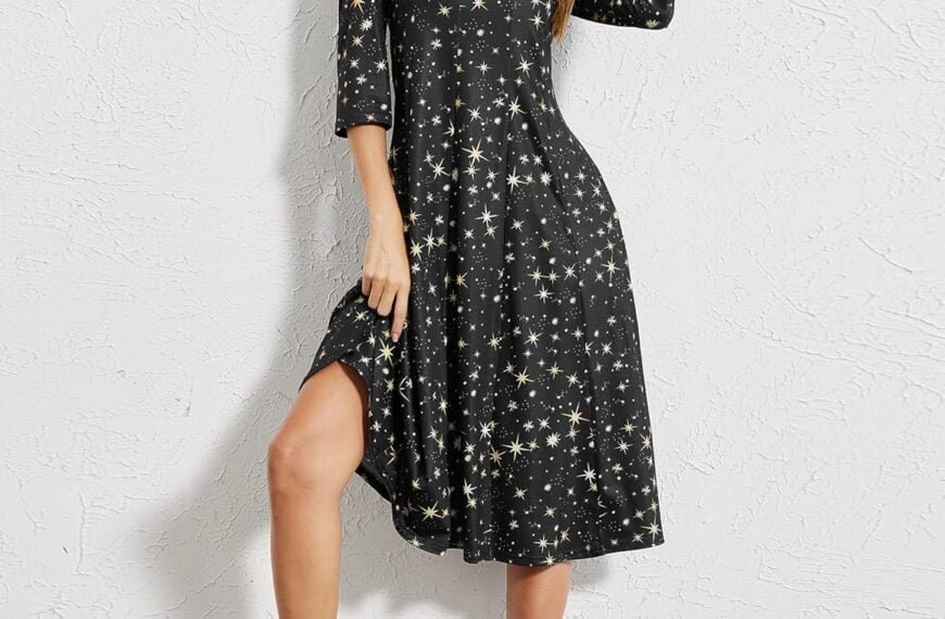 Woman posing in a starry gown with one hand on her head and the other lifting the hem of her dress, wearing heels.