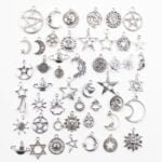 A collection of auto-draft silver charms with stars and moons.