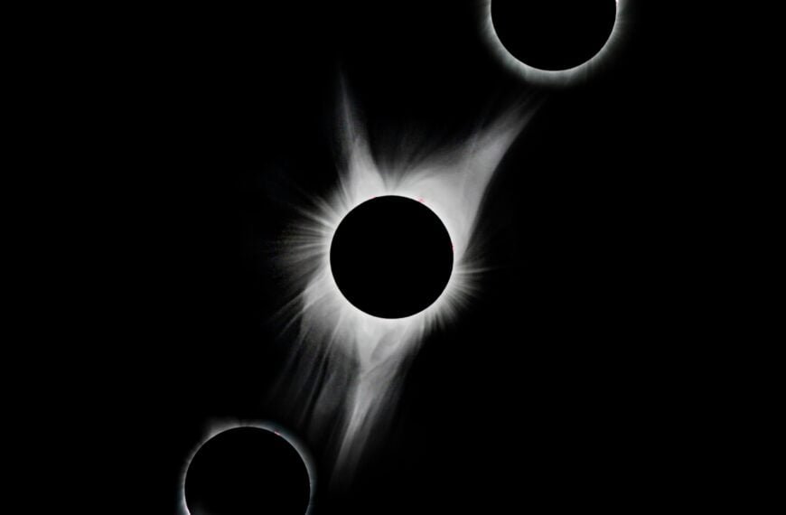 A total solar eclipse is shown with four rings in the sky.