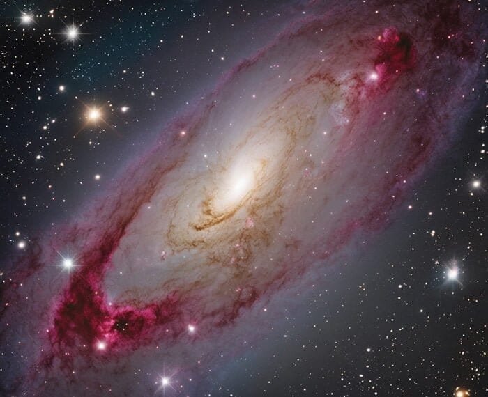 An image of NGC 1097, a barred spiral galaxy with prominent dust lanes and bright pink star-forming regions, set against a backdrop of numerous distant stars__Understanding_Galaxies__The_Building_Blocks_of_the_Universe_png.