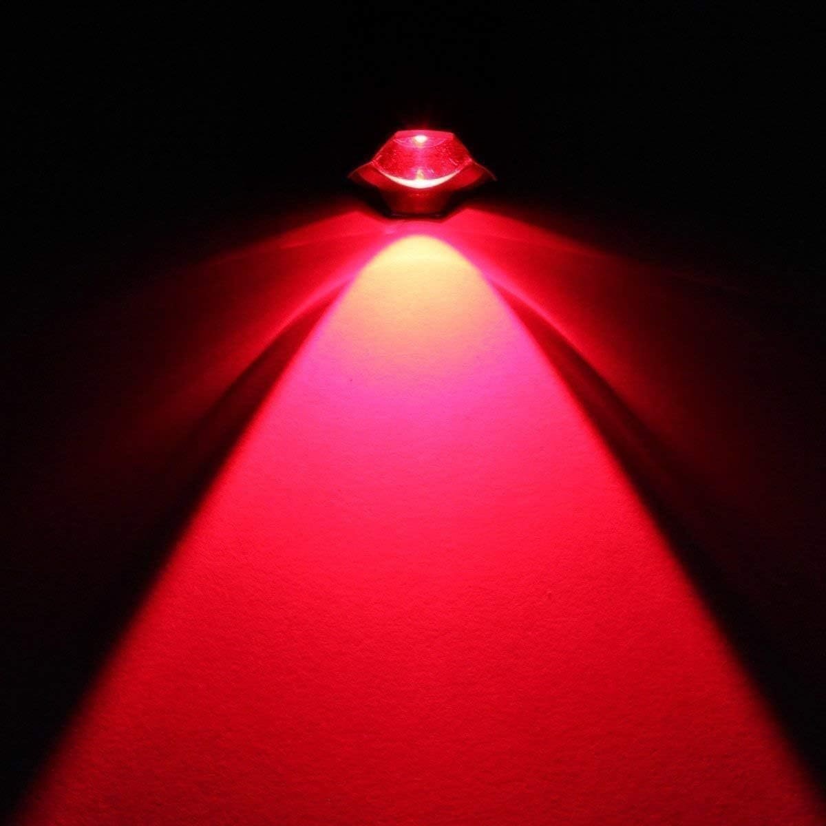 A red LED light fixture illuminates a wall, creating two distinct red light beams that form a V shape.