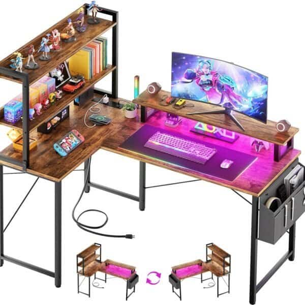 L-shaped gaming desk with dual monitors, keyboard, mouse, RGB lighting, action figures, books, and game controllers, featuring shelves and storage compartments.