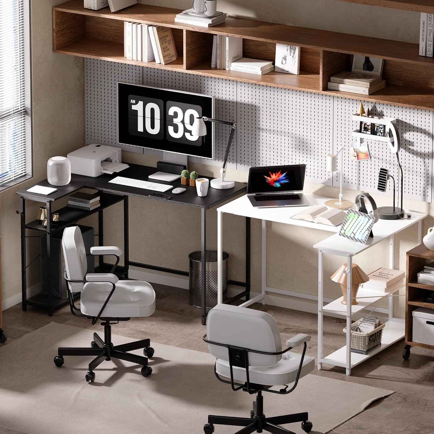 A modern home office setup with two desks, each with a chair. One desk features a large monitor and keyboard, while the other holds a laptop. Shelves and pegboards with items are on the wall.