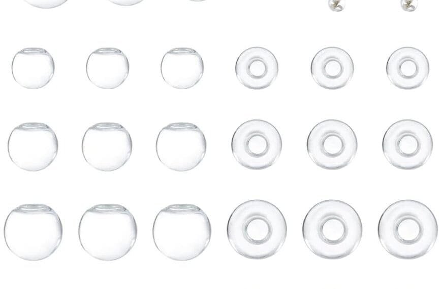 A grid of clear, round glass beads of varying sizes and two beaded earrings with pearls and golden accents.