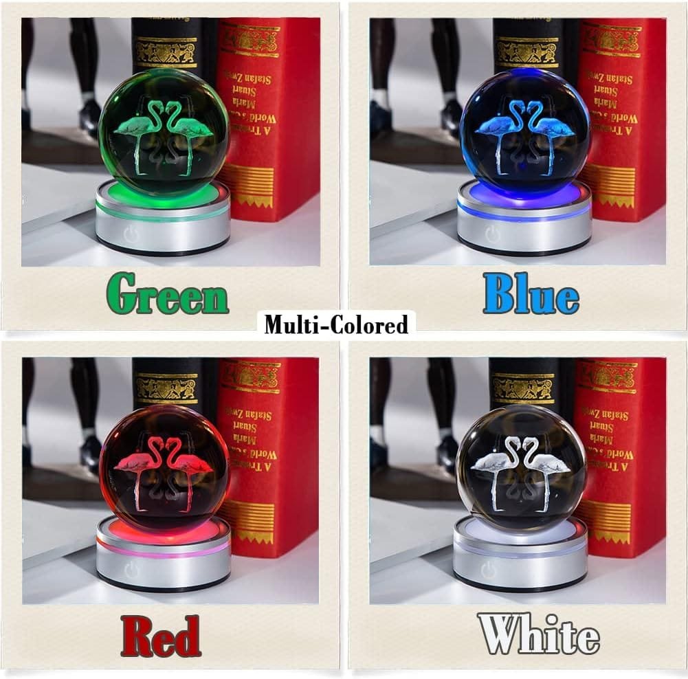 Four crystal balls with flamingo designs on rotating bases in green, blue, red, and white lighting.