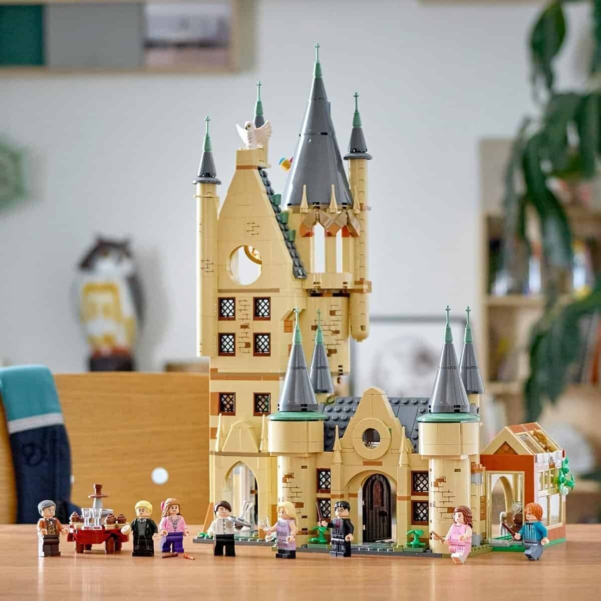 Lego Hogwarts castle set with minifigures from the Harry Potter series displayed on a table.