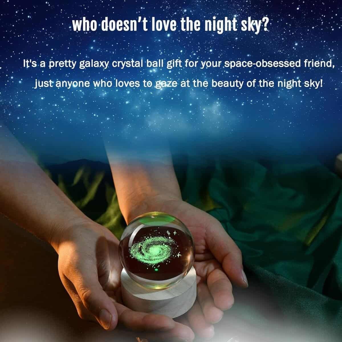 Hands holding a clear crystal ball with a galaxy design inside, against a backdrop of text about the night sky.