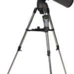 A black telescope mounted on a tripod, featuring a control panel on the stand.