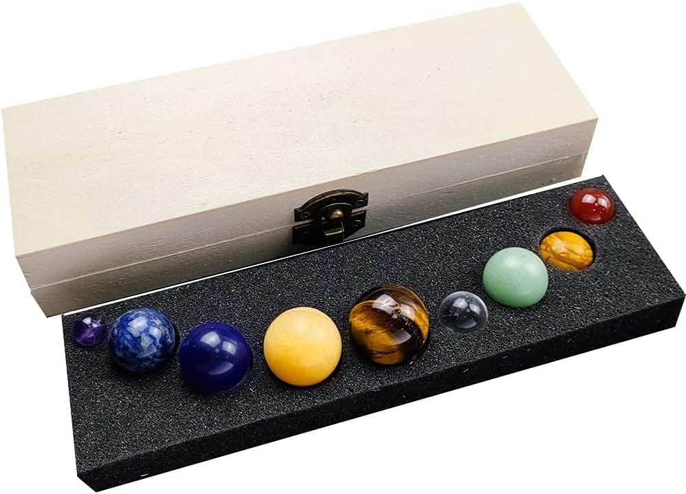 Set of nine colorful spherical stones arranged in a foam tray, accompanied by a wooden box with a latch.