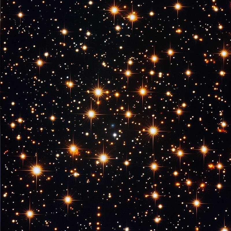 A dense field of bright stars against a dark background, each star shining with varying intensity.