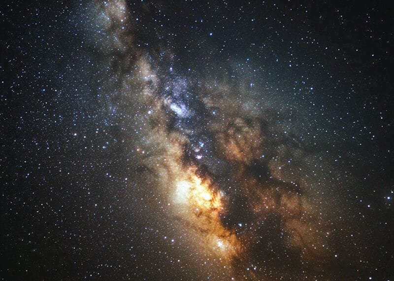 Photograph of the Milky Way galaxy reveals a mesmerizing dense band of stars and cosmic dust gracefully spread across the dark night sky.