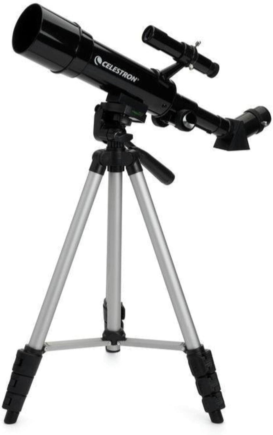A Celestron telescope mounted on a silver tripod with adjustable legs and a black optical tube.