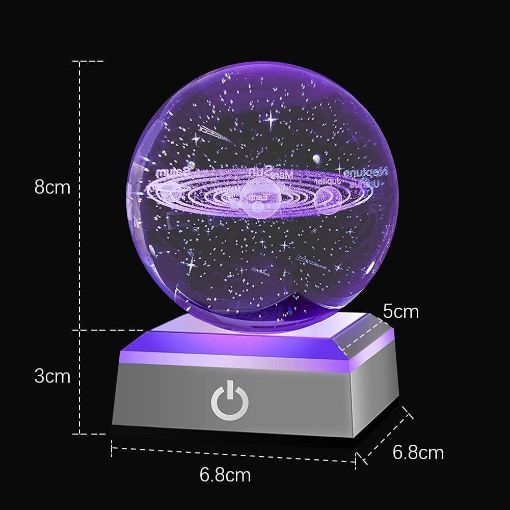 A purple illuminated 3D model of a galaxy inside a glass sphere on a square base, with dimensions marked.