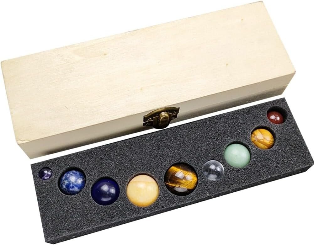 Wooden box containing eight polished gemstone spheres of various colors in a foam insert.