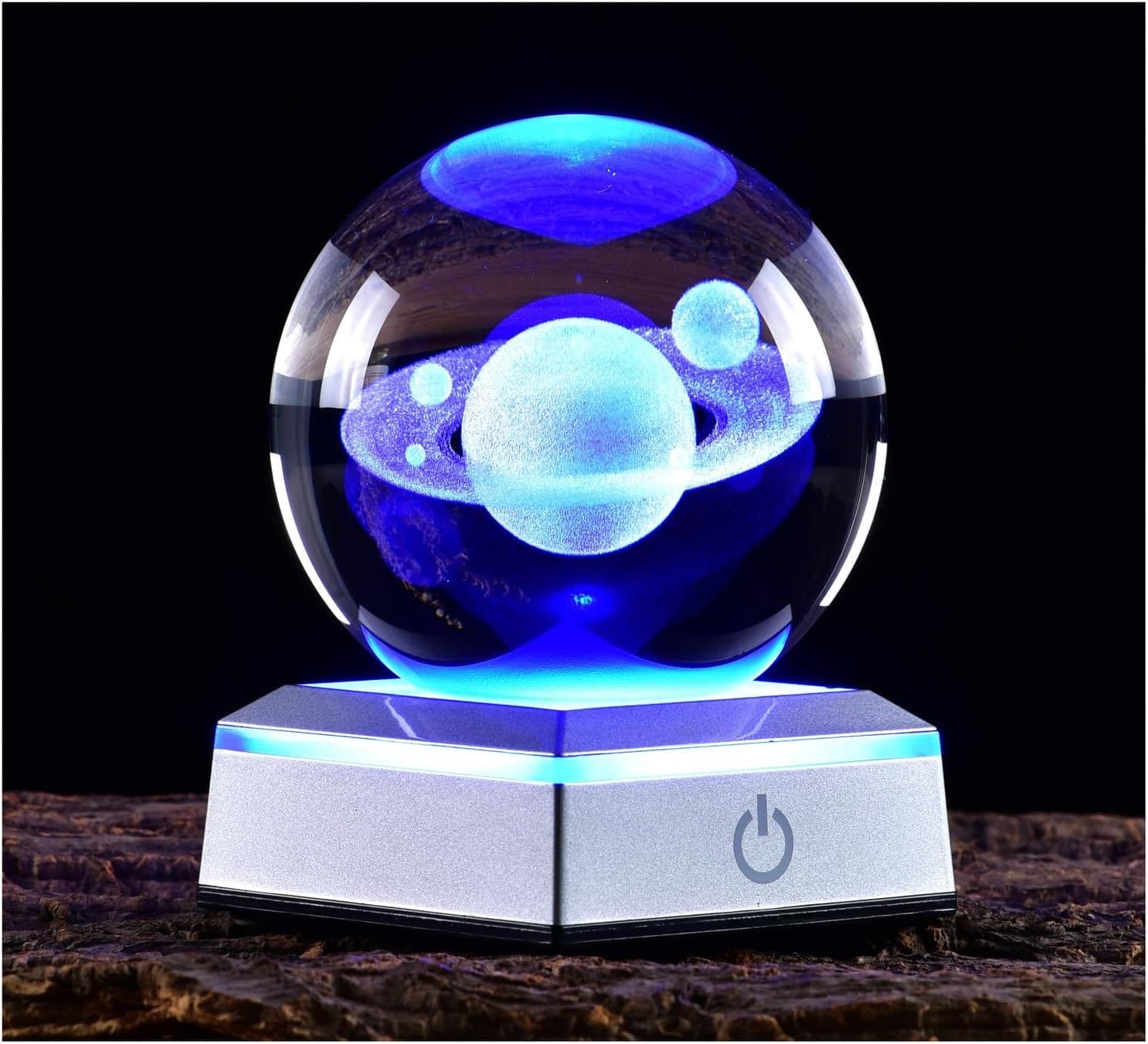 A glowing crystal ball with a 3D model of a planet and rings sits on an illuminated hexagonal base.