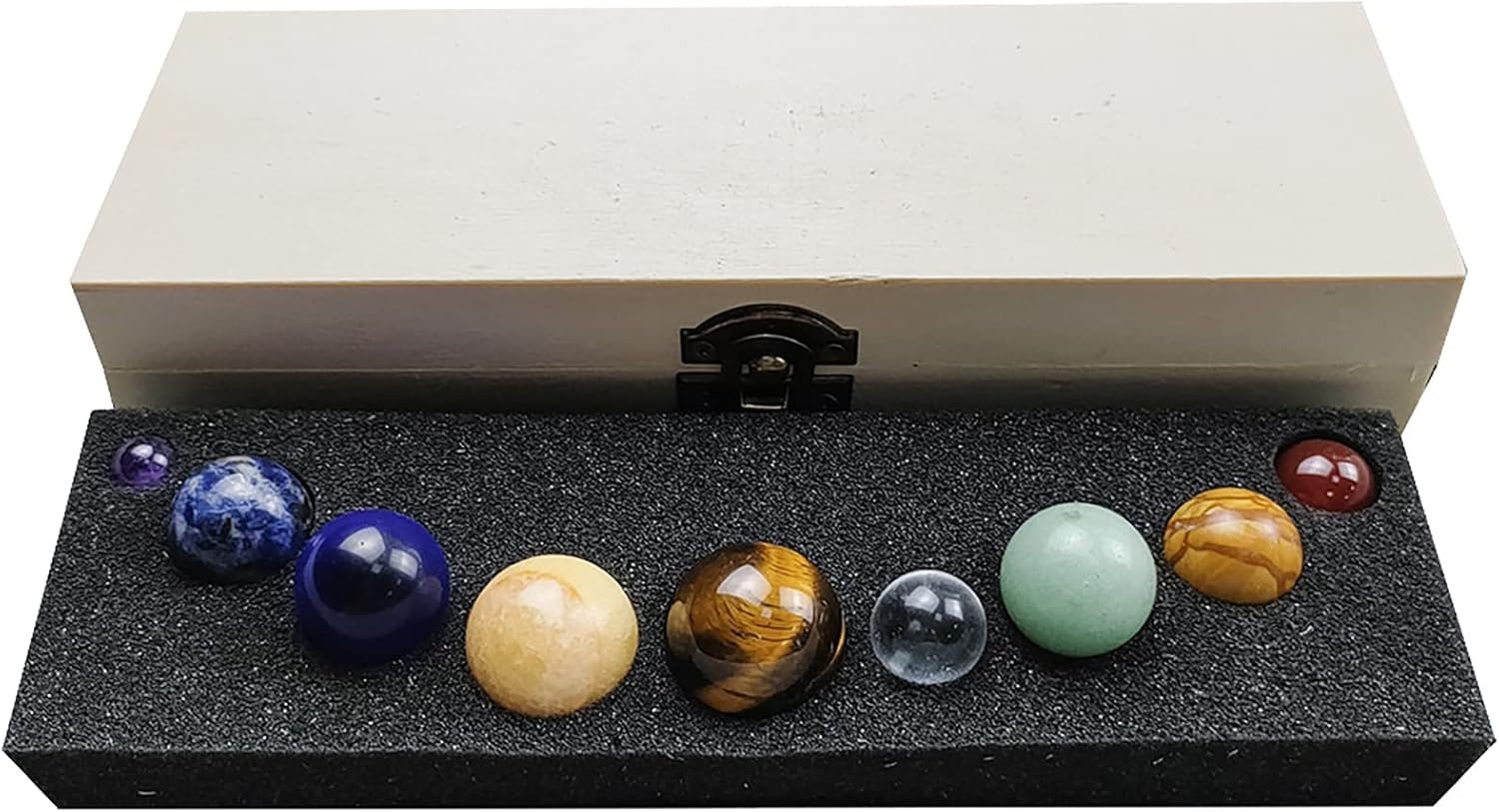 A display box with eight polished gemstone spheres in various colors and patterns on a black foam insert.