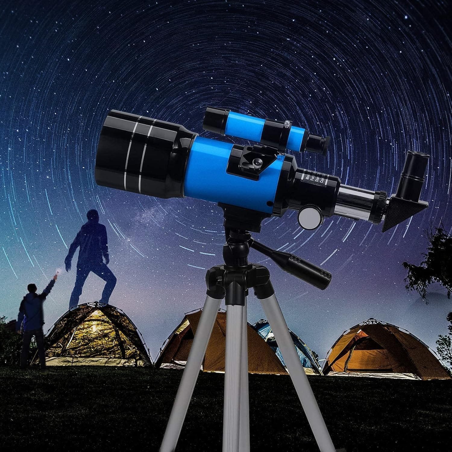 Blue telescope on a tripod against a starry sky backdrop, with tents and silhouettes of people in the background.