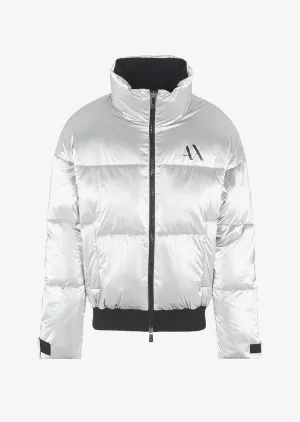 Silver puffer jacket with black trim, logo on the upper left chest, zip closure, and high collar on a plain white background.