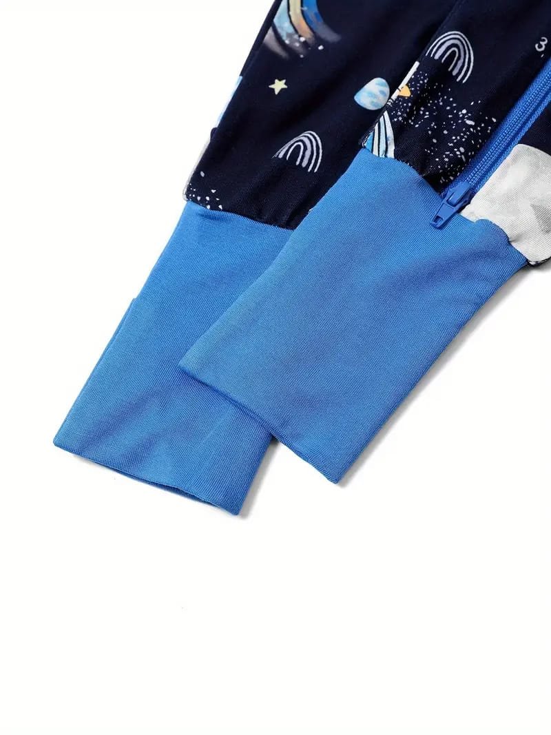 Close-up of two blue sleeves on a garment, one with a celestial pattern including moons and stars, and the other in solid light blue, both with zippers.