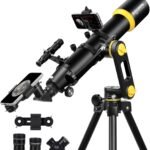 Black and yellow telescope on a tripod with attached smartphone holder, two eyepieces, and additional accessories.