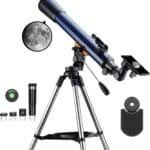 A blue telescope mounted on a tripod with accessories including eyepieces, a finder scope, a phone adapter, and a photo of the moon.