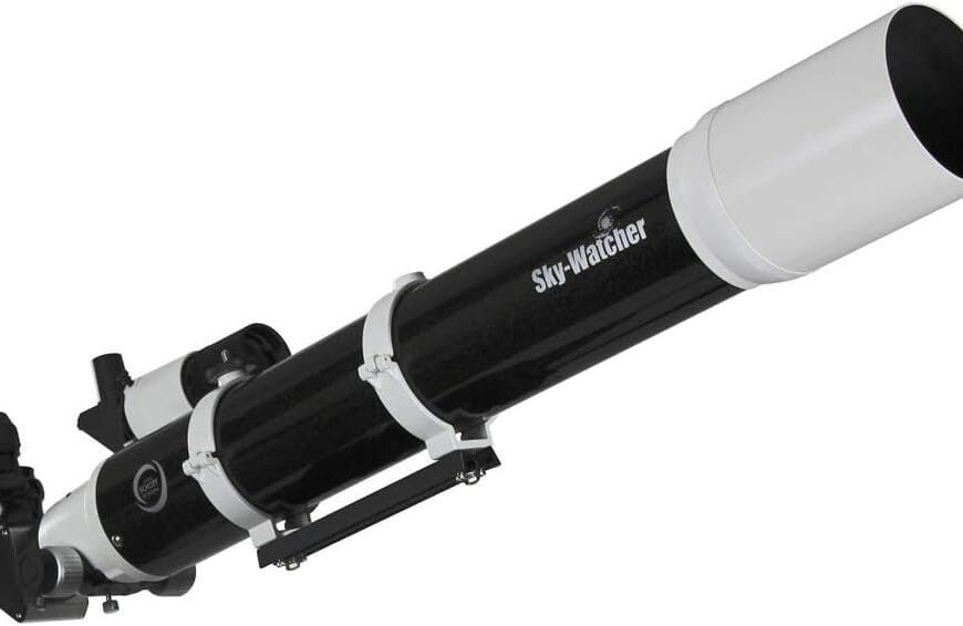 A black and white Sky-Watcher refractor telescope with an attached finderscope and eyepiece, viewed from an angled side perspective.