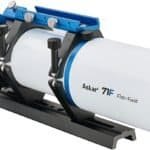 A white and blue Askar 71F flat-field refractor telescope mounted on a black rail with adjustment knobs and a large focus dial.