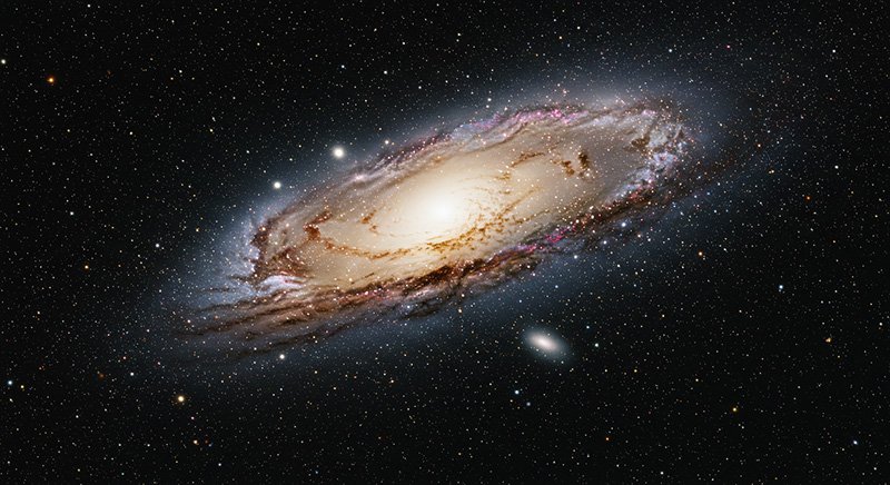 Exploring the Milky Way Galaxy 6 A bright spiral galaxy with a glowing core and spiral arms is surrounded by numerous stars and smaller galaxies against a dark space background.