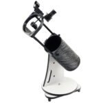 A compact tabletop Dobsonian telescope with a black optical tube, white base, and a small finder scope attached on top.