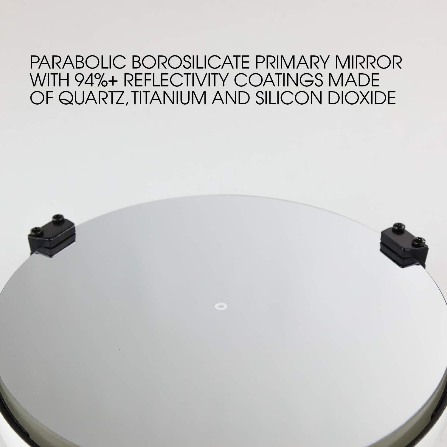 Close-up of a parabolic borosilicate primary mirror with high reflectivity coatings, featuring clamps on its edge and descriptive text above.