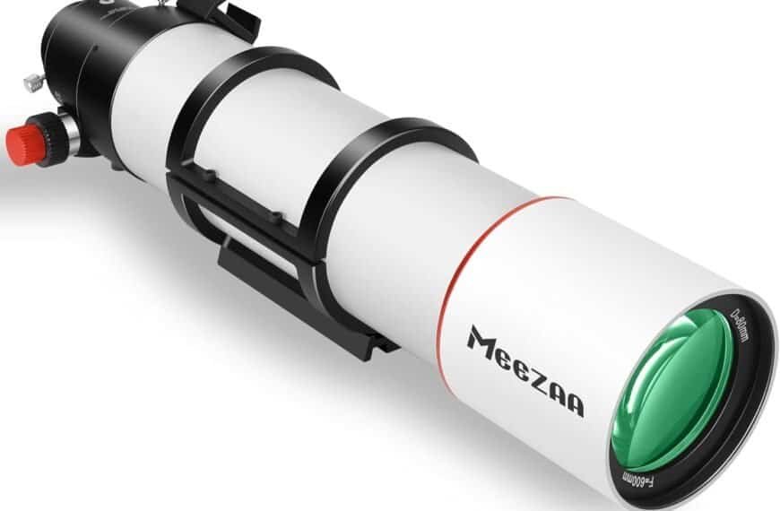 A white and black refractor telescope labeled "MeeZaa" with green lens and adjustment knobs, shown on a white background.