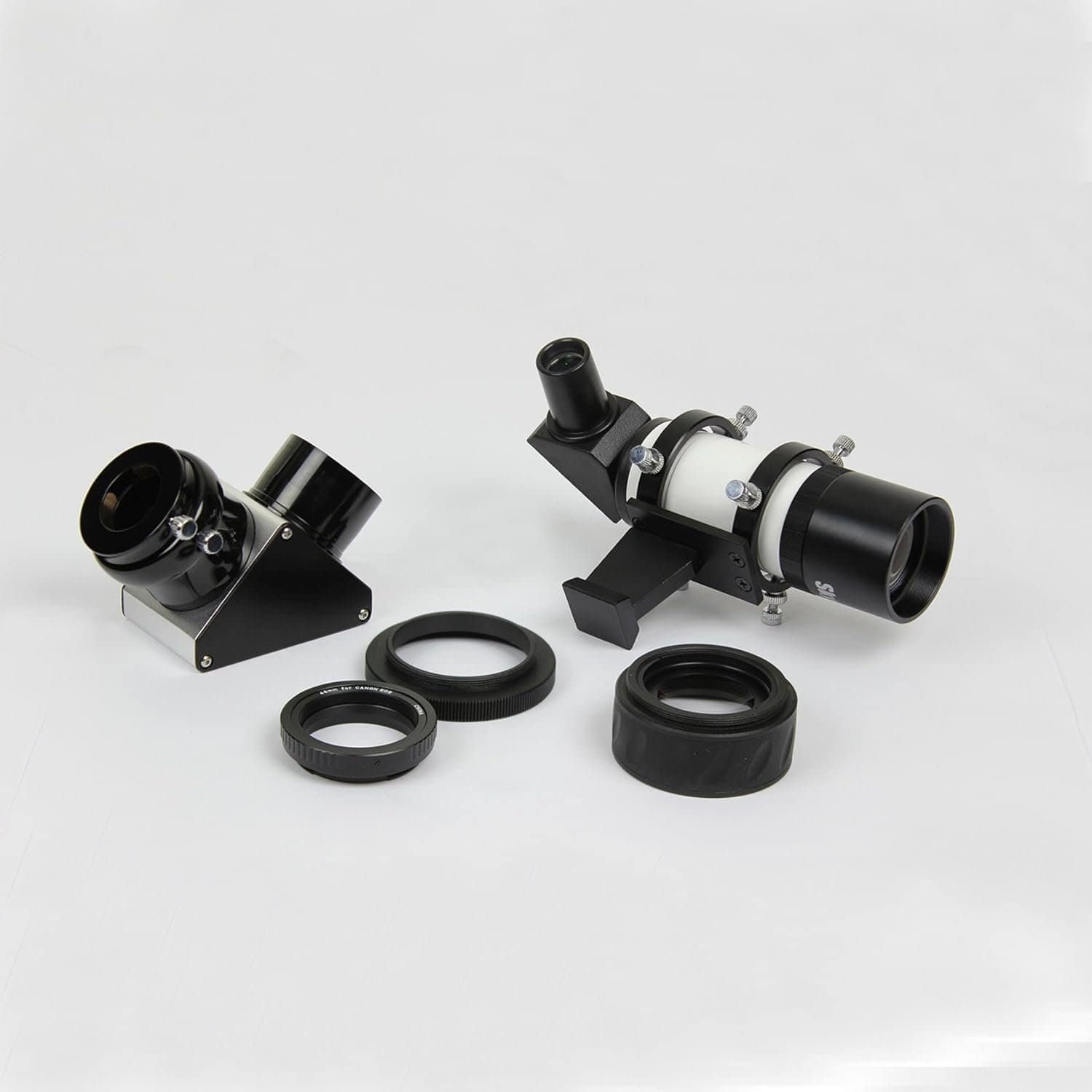 A set of telescope accessories including an eyepiece, diagonal mirror, two lens adapters, and a small finderscope on a white background.