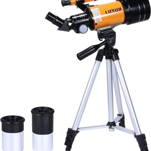 A compact orange and black telescope mounted on a silver tripod, with two additional eyepieces placed beside it.