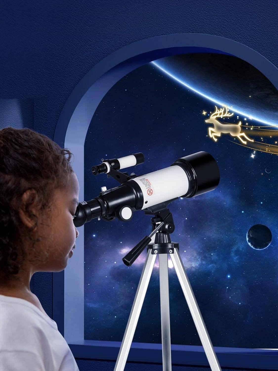 A child looks through a telescope by a window, observing a starry night sky with planets and a glowing reindeer illustration outside.