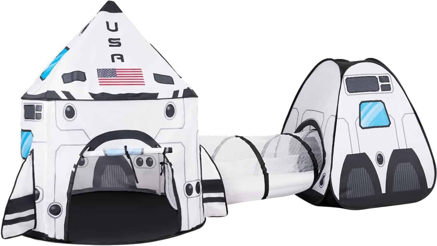 Children’s play tent set shaped like a rocket ship and space capsule, connected by a mesh tunnel, decorated with USA and an American flag.