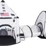 Children’s play tent set designed to look like a space shuttle and capsule with a tunnel connecting the two, featuring “USA” and an American flag on the front.