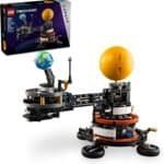 LEGO Technic set showing a mechanical model of the Earth and Moon orbiting the Sun, with the product box displayed in the background.