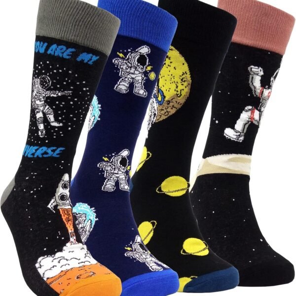 Four pairs of socks with space-themed designs, including astronauts, planets, and rockets, in various colors such as black, blue, and gray.