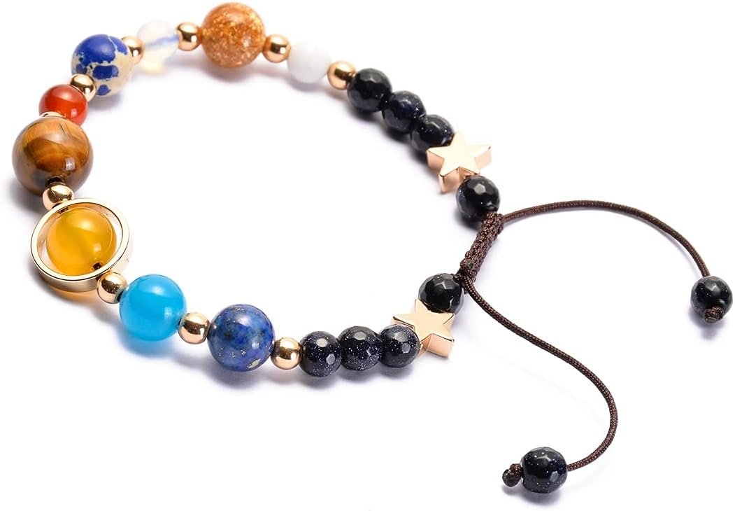 A beaded bracelet with multicolored round stones, gold spacer beads, gold star charms, and an adjustable brown cord.