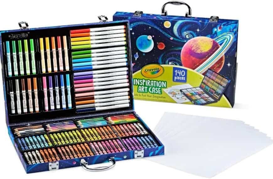 Crayola Inspiration Art Case with 140 assorted art supplies including markers, colored pencils, crayons, and paper sheets, displayed in an open carrying case with a space-themed design.