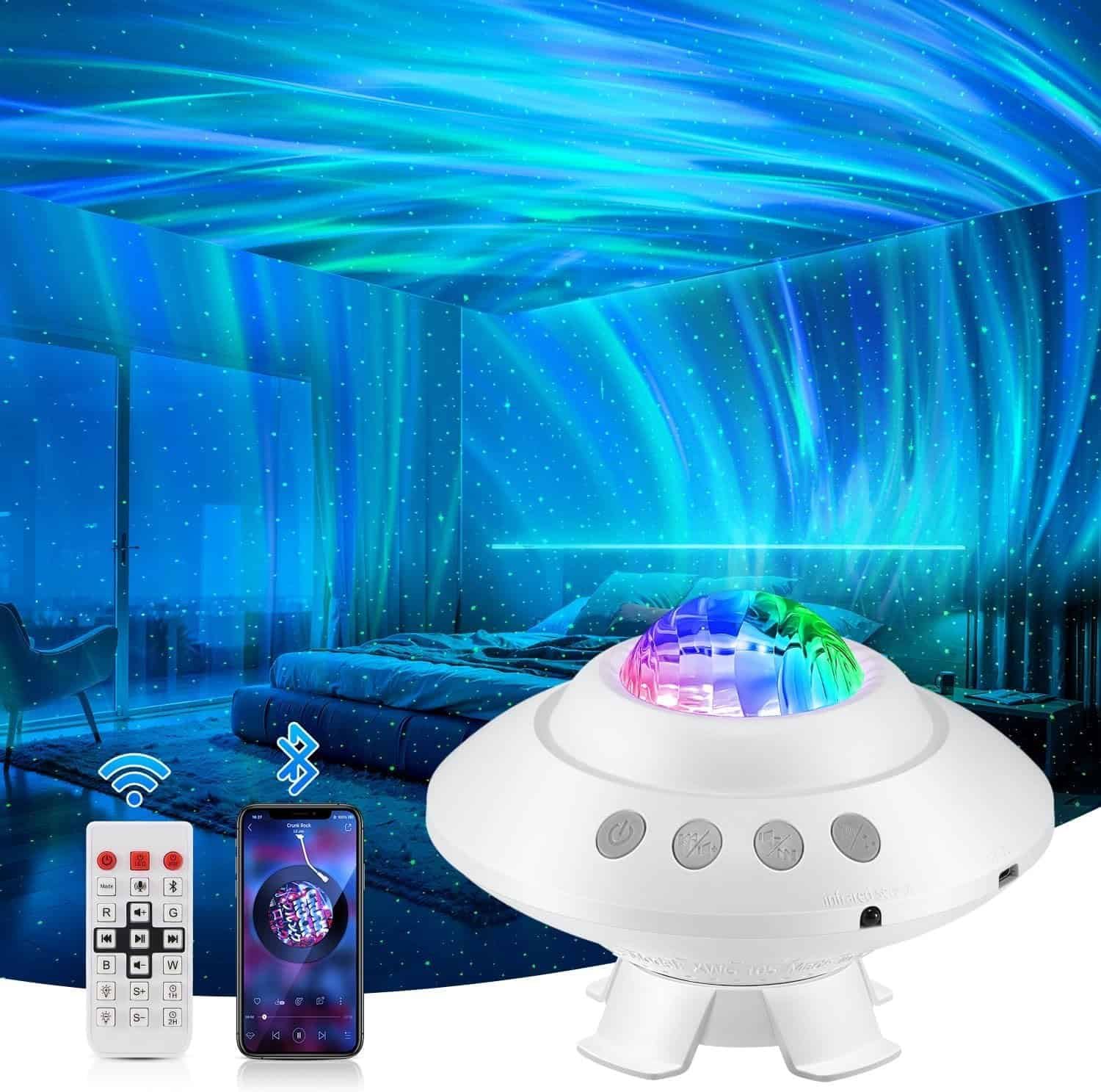 A white projector with a colorful light display projects aurora and star patterns onto the walls and ceiling of a bedroom; a remote and smartphone are shown as control options.