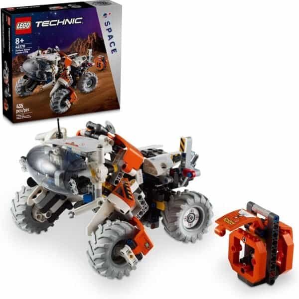 LEGO Technic Mars exploration vehicle with four large wheels, orange and white details, and robotic arm; set box shown in the background.