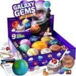 Galaxy Gems Dig Kit box with various colorful gem-filled planets, digging tools, cords, gem cards, and a child in an astronaut helmet featured on the packaging.
