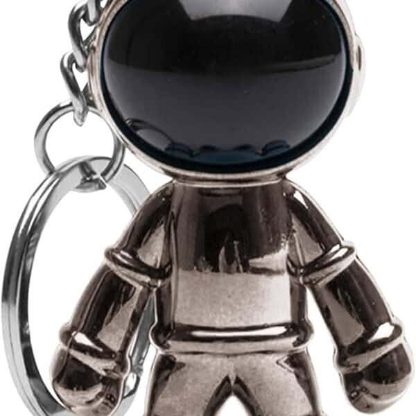 A metallic astronaut-shaped keychain with a large black visor and a small chain attached to a key ring.