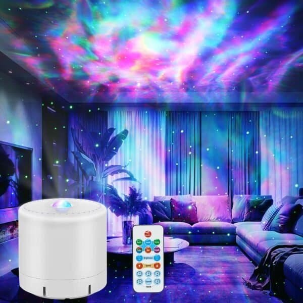 A white LED projector with a remote control projects colorful galaxy-like lights onto the ceiling and walls of a modern living room.