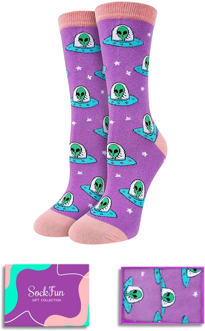 Purple socks with a pattern of green aliens in flying saucers, pink toes and cuffs, shown with a “SockFun” gift box and a close-up of the sock design.