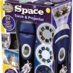 Box containing a Space Torch & Projector toy for ages 3+, with images of rockets and planets, and interchangeable projection discs showing 24 space-themed pictures.