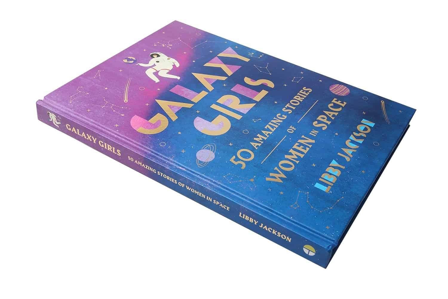 A hardcover book titled "Galaxy Girls: 50 Amazing Stories of Women in Space" by Libby Jackson with a colorful space-themed cover design.