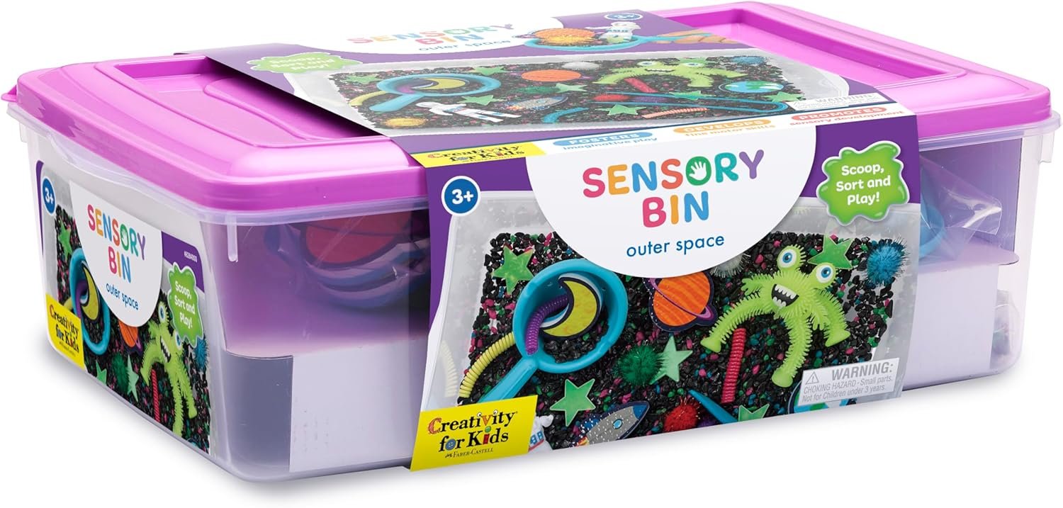 A plastic bin labeled "Sensory Bin Outer Space" contains assorted space-themed sensory toys and tools for children aged 3 and up.